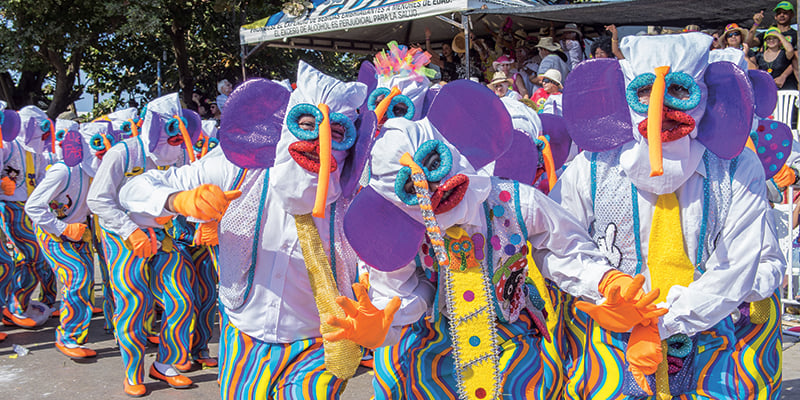 Grupo de personas disfrazadas de elefantes en un carnaval.