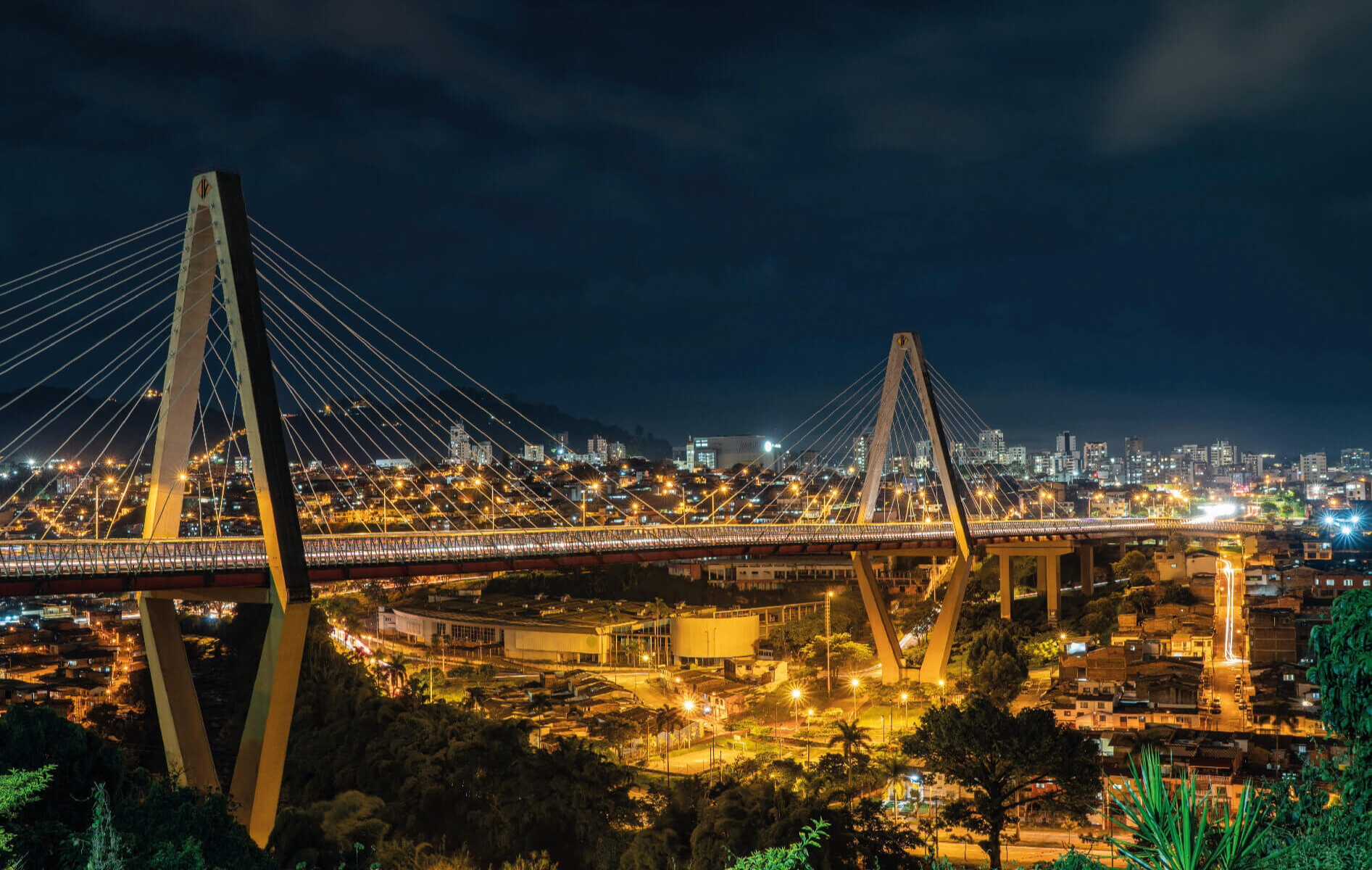 Puente colgante iluminado en la noche.