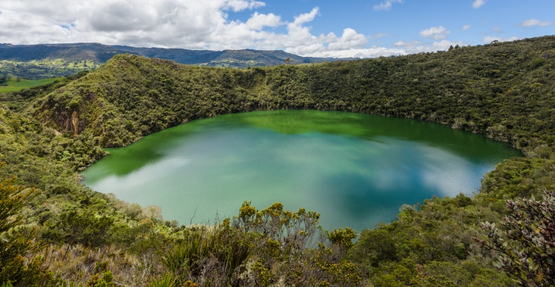 Lake Guatavita surrounded by lush foliage in Colombia’s Eastern Andean region 