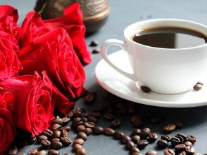 red roses and a cup of coffee, a Colombian classic. Photo by Ermolenko Aleksandra. Shutterstock gallery.