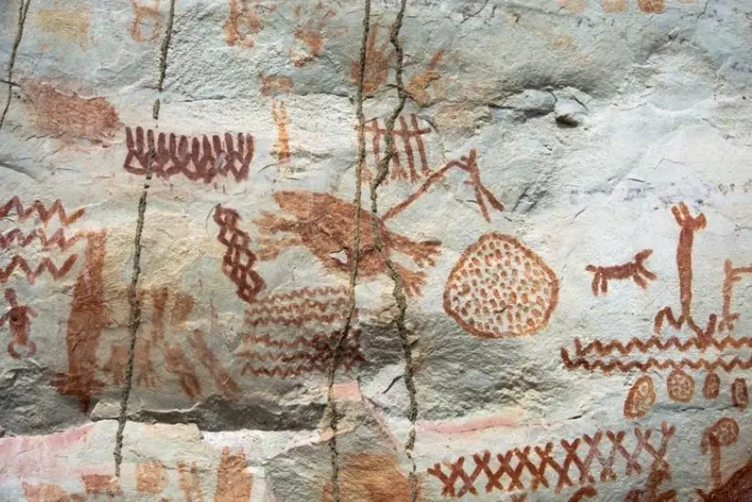 Primitive art with red pigments on a natural white rock