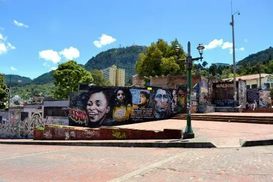 Graffiti in Bogota with portraits of artists on a wall in an urban zone