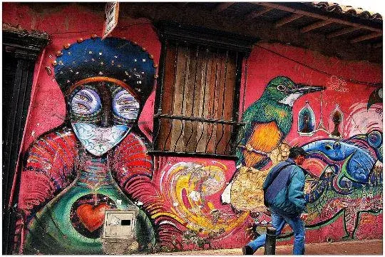 Colorful street art in Bogota with birds and oversized female figures