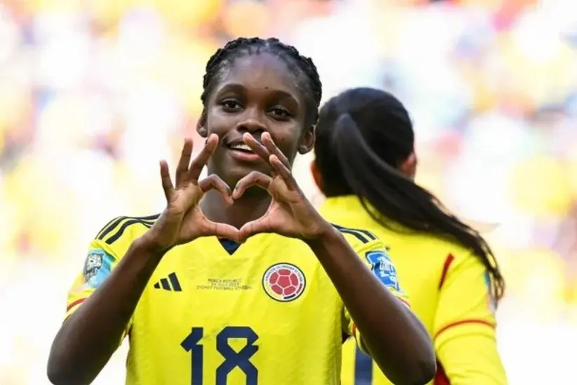 Jugadora de la selección Colombia femenina celebrando con gesto de corazón tras un gol