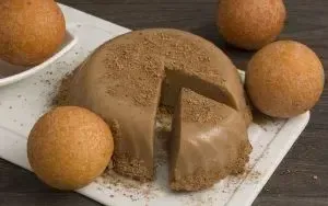 Custard served on a plate with doughnuts around it