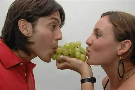 Couple eating grapes at New Year's Eve celebration