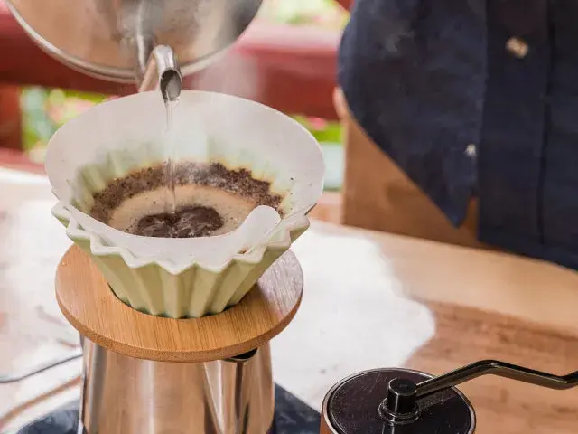 Process of pouring hot water to prepare filtered coffee.