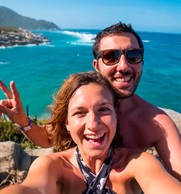 Three stories that’ll inspire you about living in Colombia - A happy couple taking a selfie in Tayrona National Natural Park in Colombia Colombia Country Brand