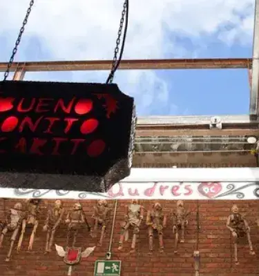 Hanging sign that says Bueno, Bonito y Carito (Good, Nice and Expensive)