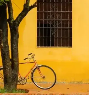 Bicycle next to yellow wall on colonial street