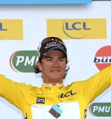 Ciclista colombiano Carlos Betancur con los brazos en alto en el podio.