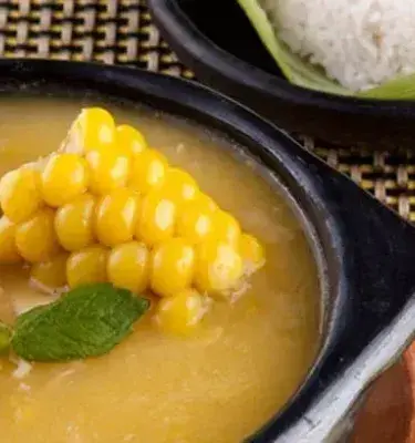 Ajiaco colombiano con mazorca, pollo desmenuzado y arroz blanco