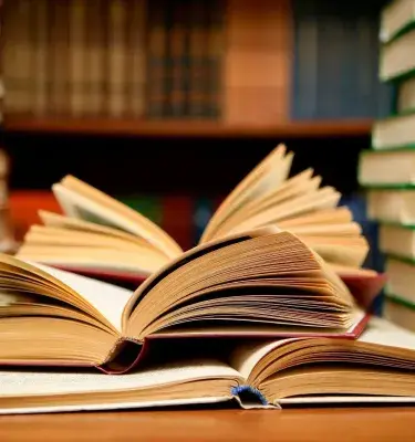 Open and stacked books in a library