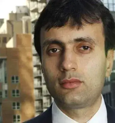 Retrato de hombre en traje formal con edificios de fondo en ciudad