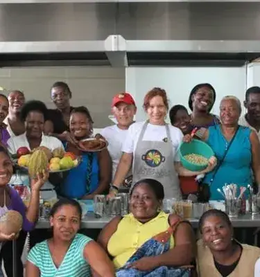 Group of Afro-Colombian women with ingredients in a traditional cooking workshop