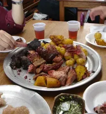 Colombian fried meat dish with beef, blood sausage, and creole potatoes