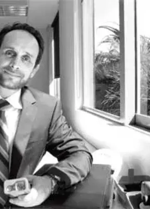 Man in a suit next to a window in an office