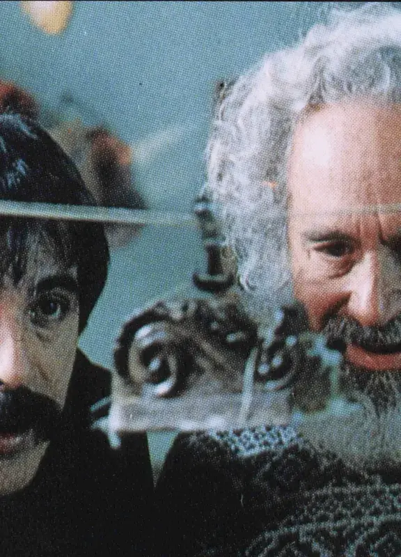 Close-up of two men looking at something with curiosity.