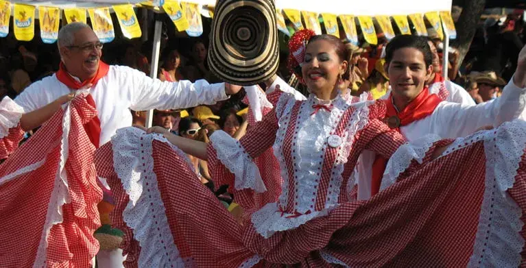 Dancers in red and white costumes at the Barranquilla Carnival.